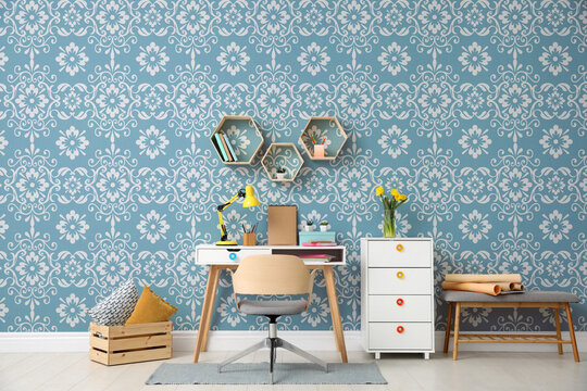 Modern room interior with furniture near patterned wallpapers