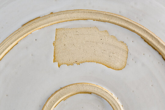 Abstract showing bottom of a glazed pottery serving dish