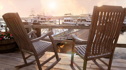 Two rocking chairs on the deck by the marina