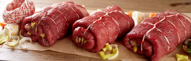 Prepared raw beef roulades with pickle and bacon