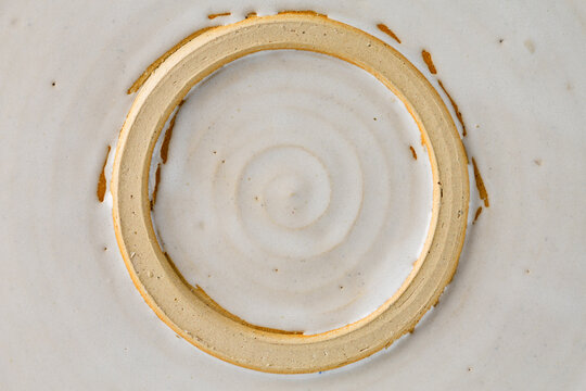 Abstract spiral in a circle on the bottom of a glazed pottery serving dish