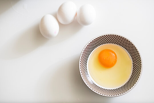 Group of fresh eggs on white table.