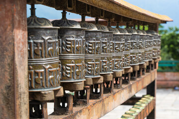 Obraz na płótnie Canvas Picture of buddhist prayer wheels in a row