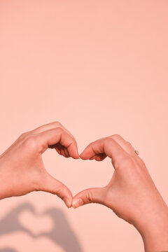 Hands making a heart sign.