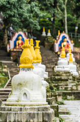 Several small stupas with "Eyes of Buddha" painting