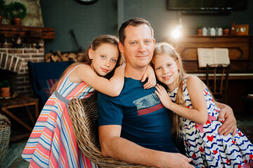 dad hugs two daughters. father day. single father.