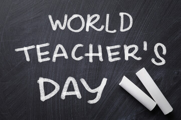 Text World Teacher's Day and chalk on blackboard, top view. Greeting card design