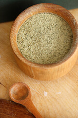 Pile of fresh flour and bowl with pumpkin seeds