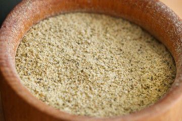 Pile of fresh flour and bowl with pumpkin seeds