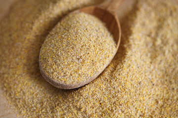 ground mustard in a wooden spoon on the table