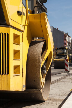 Heavy Construction Equipment Rebuilding a Streeet in City