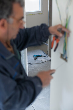 Senior electrician working at the construction site