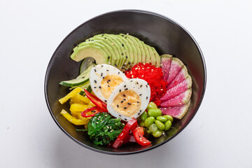 Organic food. Tuna poke bowl with crystal noodles, fresh red cabbadge, avocado, cherry tomatoes. Food concept poke bowl on white background, Top view, Closeup.