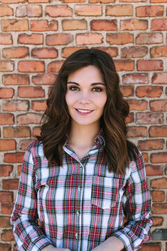 Young Casual Woman over Against a Brick Wall