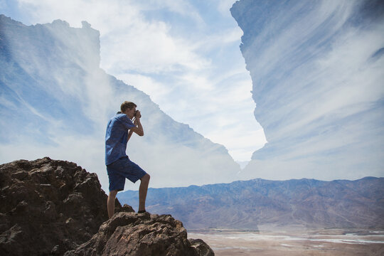 Double exposure of a young man taking a photograph