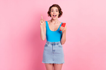 Photo of lovely pretty young journalist girl hold telephone finger up open mouth have idea appointment mayor interview wear denim mini skirt blue singlet isolated pink color background