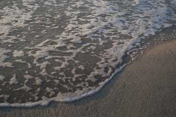 The texture of the raging stream of sea water foaming on the surface.