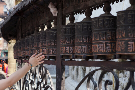 A hand spinning prayer wheel in Kathmandu, Nepal.
