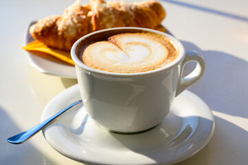 Breakfast coffee, Italian classic cappuccino with milk foam served in cafe