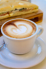 Breakfast coffee, Italian classic cappuccino with milk foam served in cafe