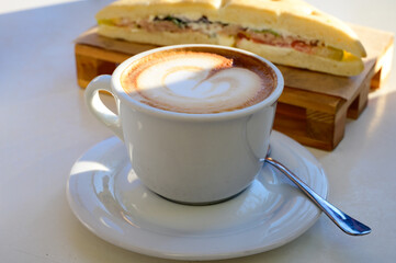 Breakfast coffee, Italian classic cappuccino with milk foam served in cafe