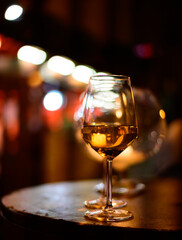 Two glasses of cold dry white wine served outdoor in cafe at night in Italy