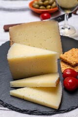 Spanish tapas, manchego cheese made, green olives served with glasses of dry fino sherry wine