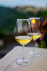 Two glasses of cold dry white wine served outdoor in cafe at night in Italy