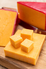 Red waxed yellow cheddar cheese close up