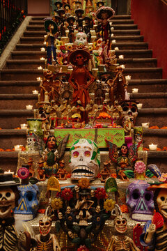 Day of the Dead decorations and candles line a staircase in Mexico City