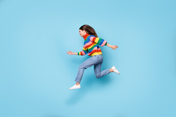 Fototapeta na wymiar Full length body size profile side view of her she nice attractive energetic cheerful girl jumping running fast speed discount isolated blue pastel color background