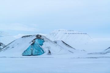 A turquoise iceberg in Spitsbergen, Svalbard. 
Winter postcard from the arctic. 