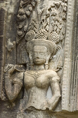 Fototapeta na wymiar Stone bas relief carvings of a devata deity at Ta Som, Angkor, Siem Reap Cambodia