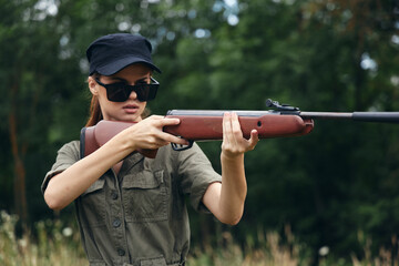 Woman soldier Weapon in hand hunting sunglasses black cap 