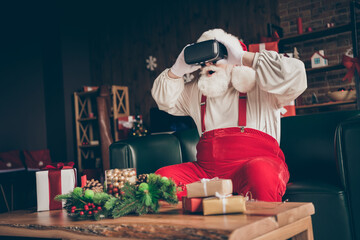 Photo of surprised santa claus sit couch addicted player play video game innovation technology watch 3d reality glasses wear red cap headwear in house indoors x-mas christmas ornament - Powered by Adobe