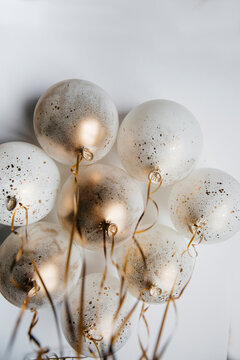 Party golden and white balloons in front of the ceiling
