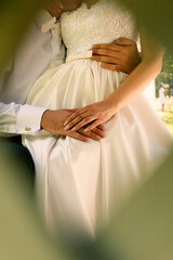 groom hugs the bride, close up