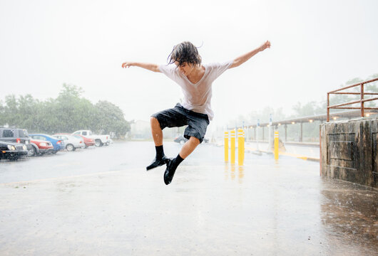 Boy dances in the rain