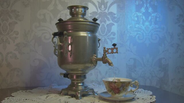 Pouring Hot Water From a Vintage Samovar Metal Tea Kettle into a Gorgeous Cup. Video Dolly Arc Right