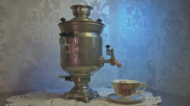 Vintage Samovar Metal Tea Kettle Illuminated by Blue and Pink Light. Video Dolly Arc Right