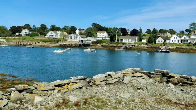 Looking across Mackerel Bay in Harpswell with old Dock and houses in the background with trees  4K