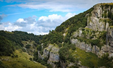 Cliffs of Cheddar Gorge from high viewpoint. High limestone cliffs in canyon in Mendip Hills in Somerset, England