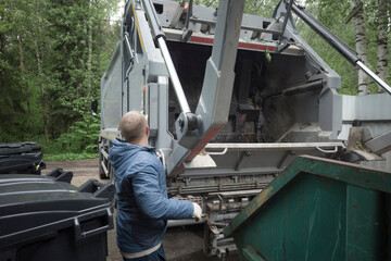 Fototapeta na wymiar Garbage truck operator