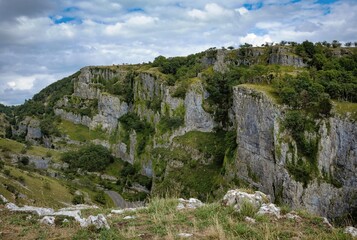 Fototapeta na wymiar Cliffs of Cheddar Gorge from high viewpoint. High limestone cliffs in canyon in Mendip Hills in Somerset, England