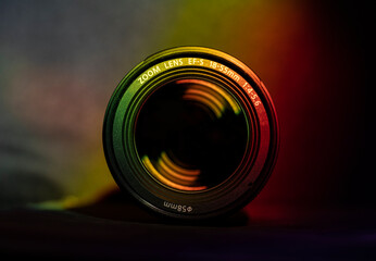 View of the glass elements in the lens of a camera. Reflected target with red and yellow light....