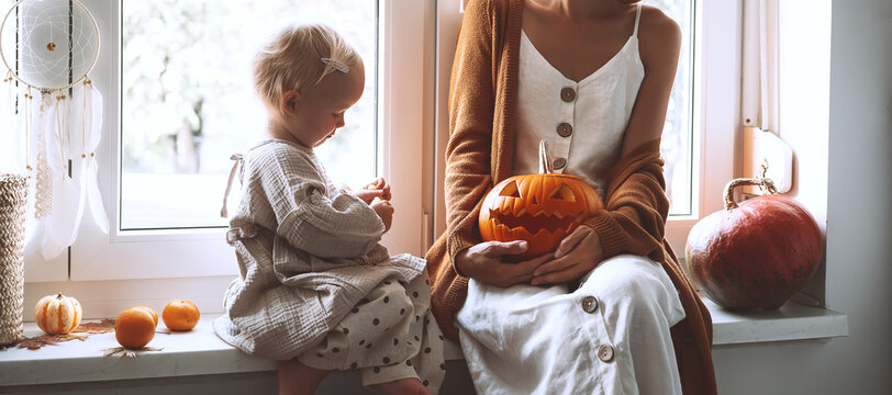Happy family preparing for Halloween at home together.