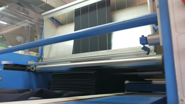 Textile factory. Automated modern fabric production. Machines make fabric from threads.
