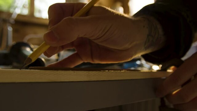 carpenter at work, marking with a pencil in close up