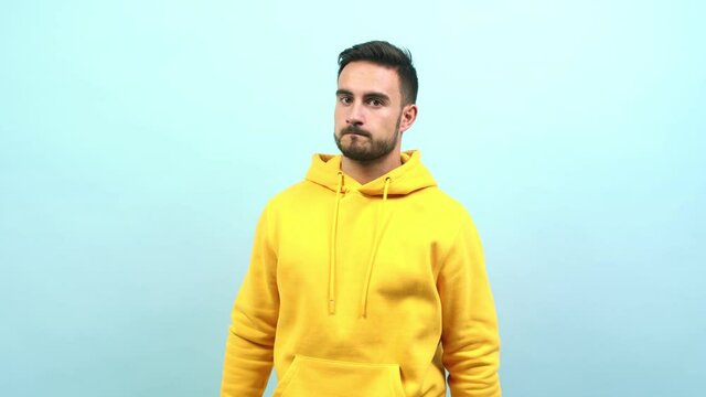 Young caucasian man tired and bored, doing a timeout gesture, needs to stop because of work stress, time concept