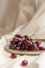 fresh juicy grapes on a plate on a light background